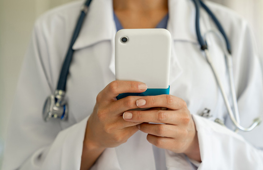 Female physician holding a mobile phone
