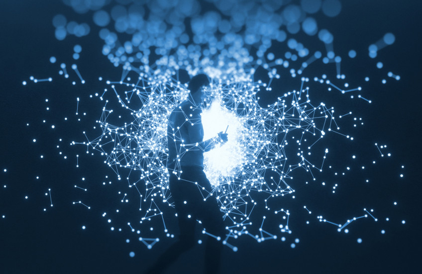 man with cell phone walking through illuminated globes and connecting nodes