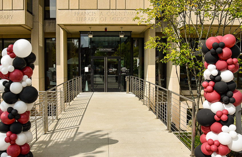 Entrance to Countway Library, flanked by balloons.