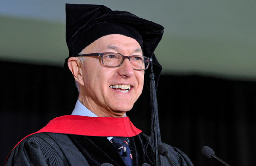 Daley in regalia speaking into microphone