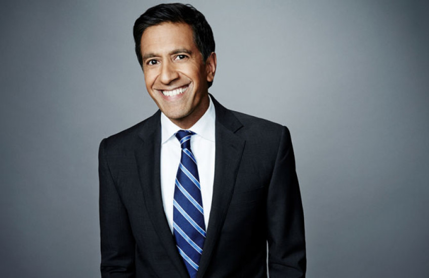 Man in a blue suit and stripe tie smiling