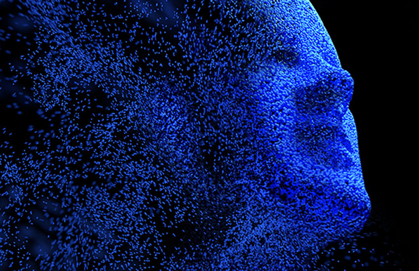 Abstract image of human face in blue dissolving