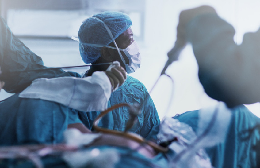 Surgery taking place in a busy operating room.