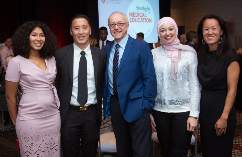 Photo of 4 students and former student with Dean Daley, all smiling at the camera