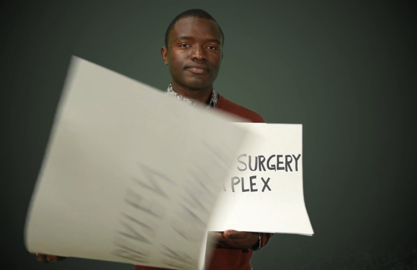A student holds up signs