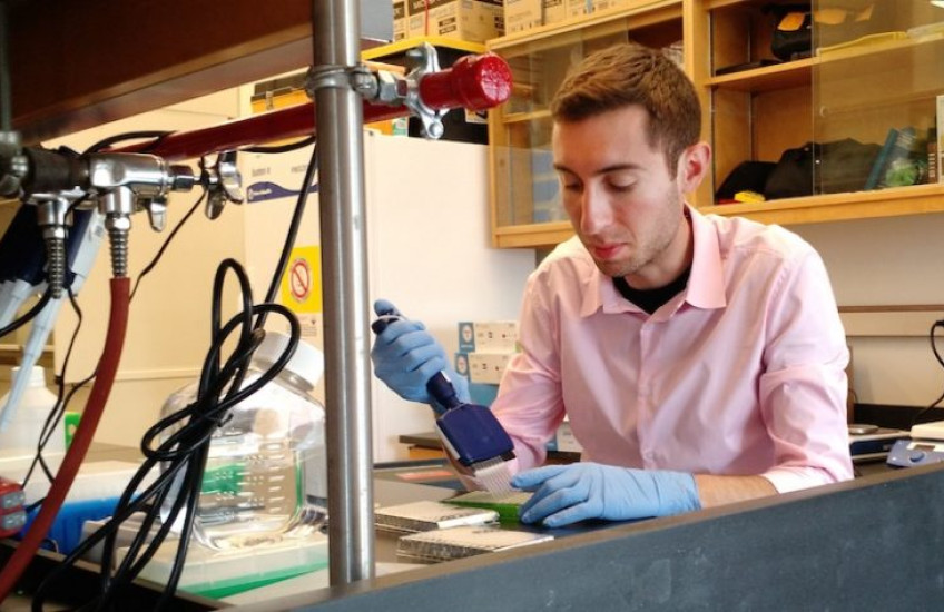 Man pipetting at a lab bench