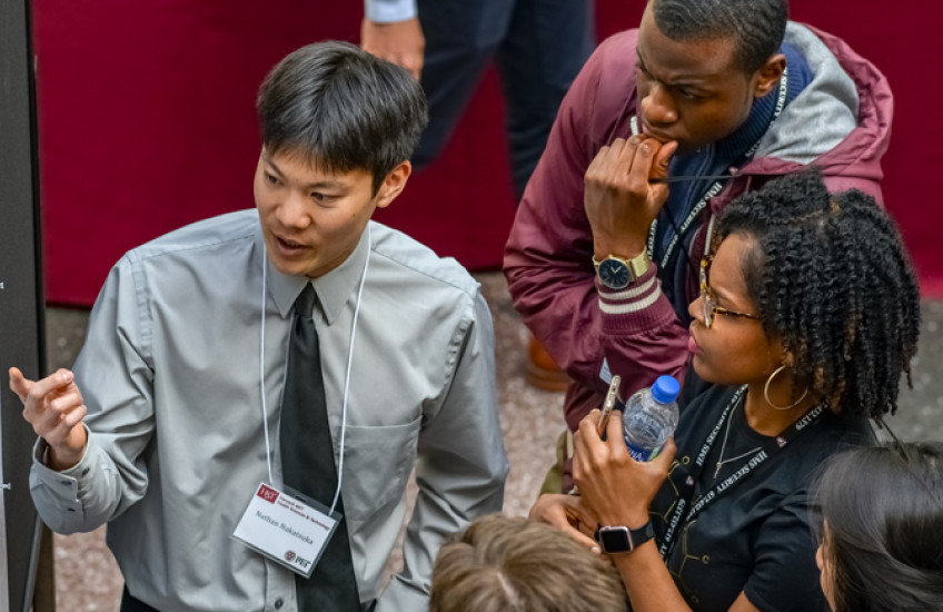 HMS PhD student describing his project to other students