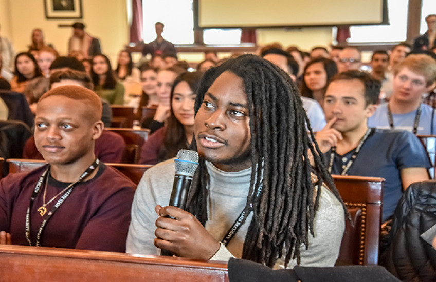 Audience at Amos Lecture. Student asks question into microphone.