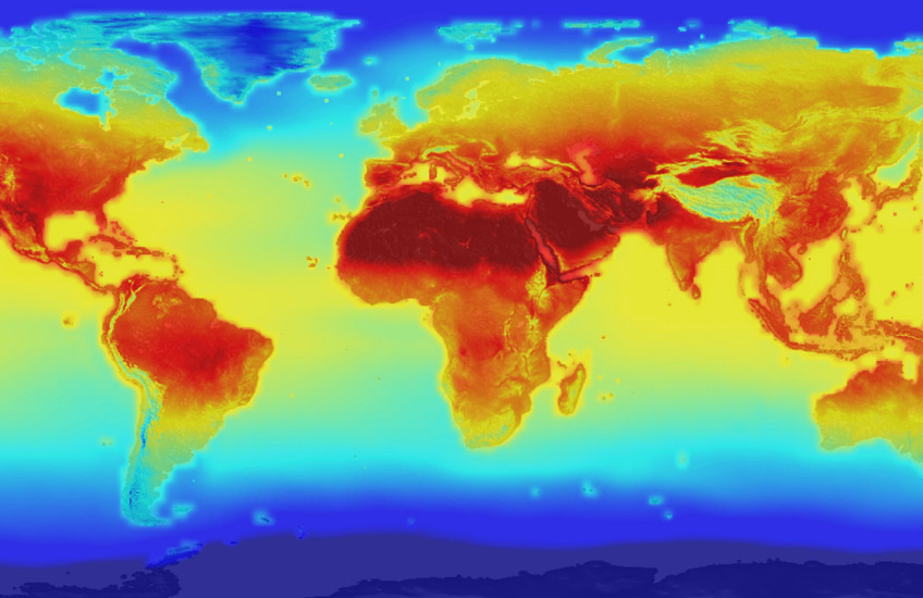 A false color map of the world with red, yellow and orange indicating temperature change due to greenhouse gas emissions.