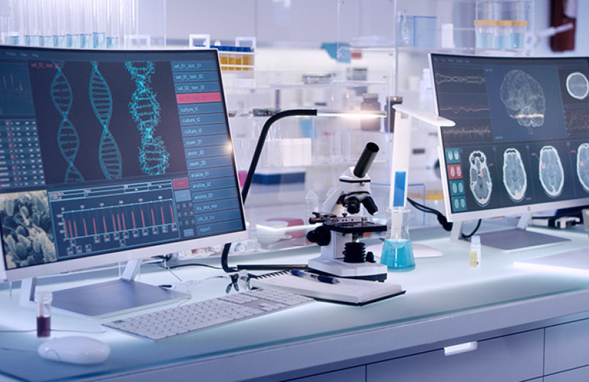 photo of a gleaming modern lab with large computer screens and microscopes