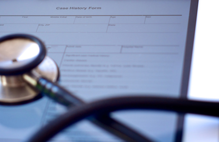 A stethoscope on a case history form