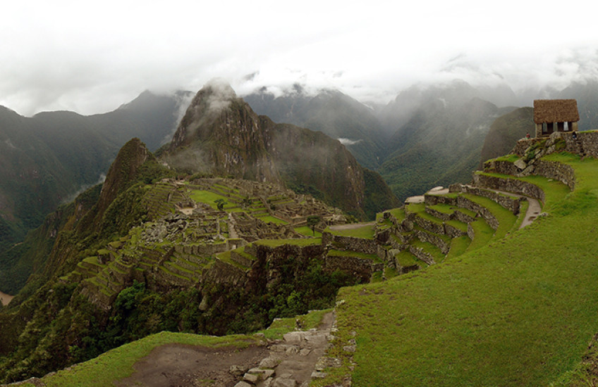 panorama of Machu Picchu site beneath cloudy sky