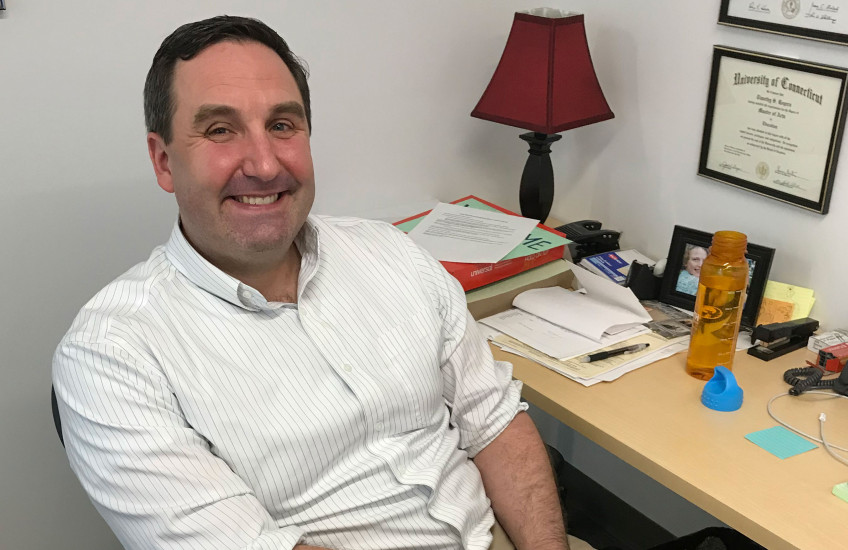 Timothy Rogers sitting at desk