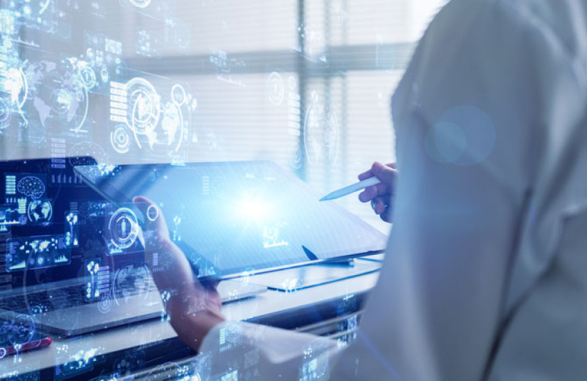 Scientist in white coat holding a table with science concept images overlaid