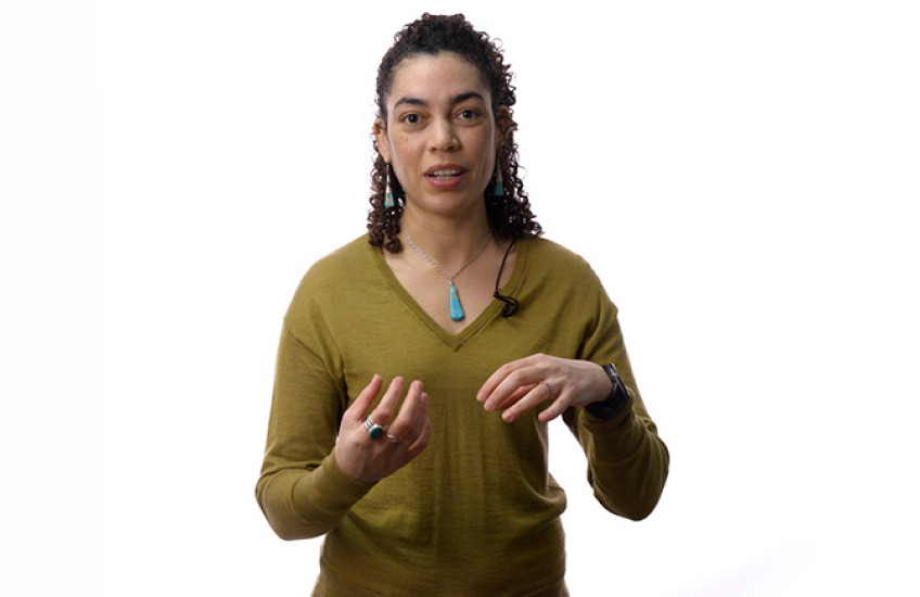 Aleena Garner standing in front of a white background
