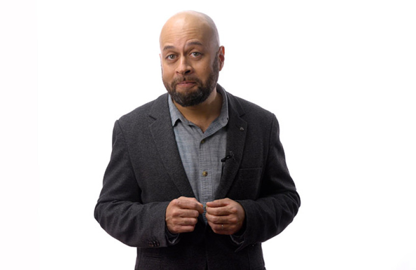 Carlos Ponce standing in front of a white background