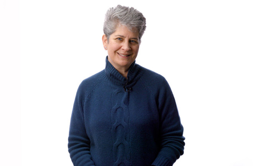 Caroline Shamu stands in front of a white background