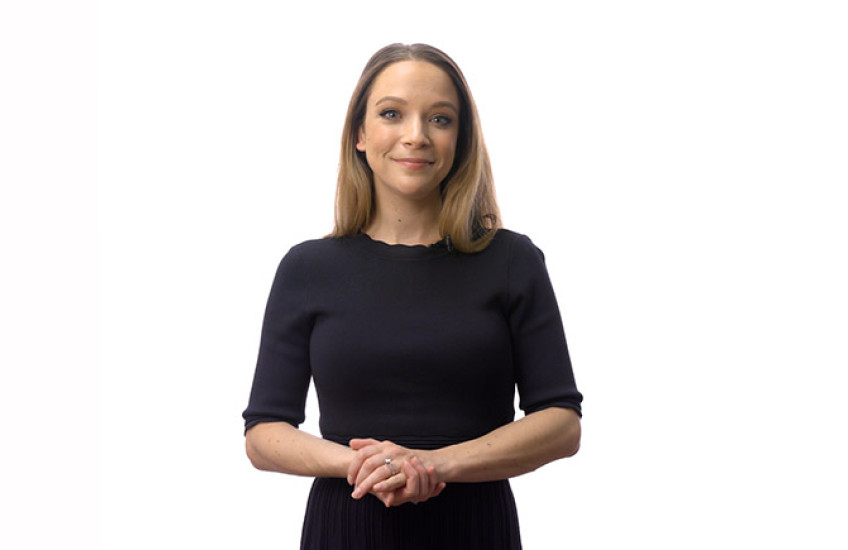 Lauren Orefice stands in front of a white background