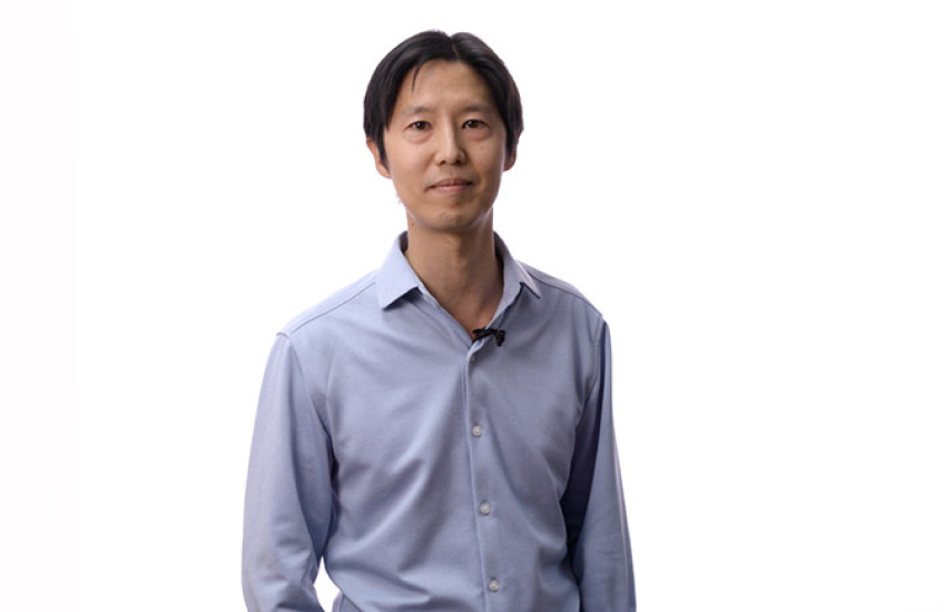 Wesley Wong standing in front of a white background