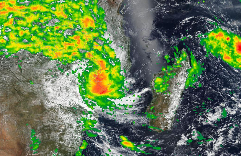 A satelite image of a swirling storm above Malawi and Madagascar, with bands of green, yellow, orange and red showing increasingly intense rainfall.