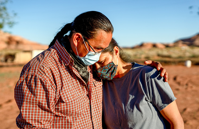 A husband and wife comfort one another during the Coronavirus shutdown on the Navajo nation in Arizona