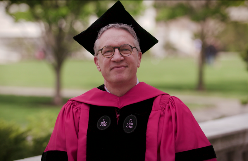 Dr. Giannobile, dressed in academic regalia, speaking outdoors