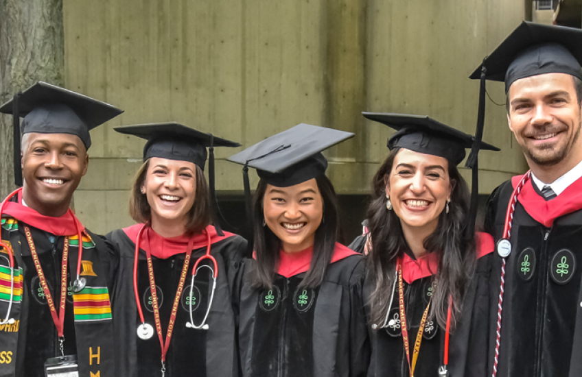 Image of happy graduates standing together