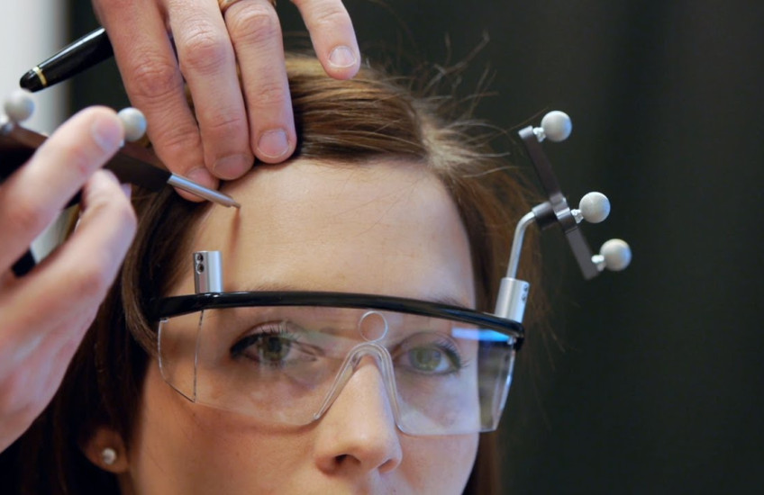 A scientist scans a woman's brain