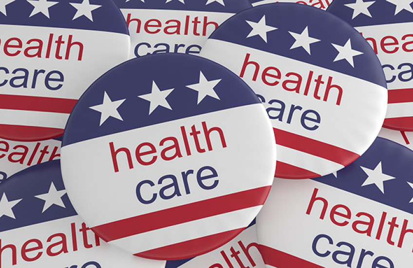Multiple political buttons with U.S. flag and health care printed on them