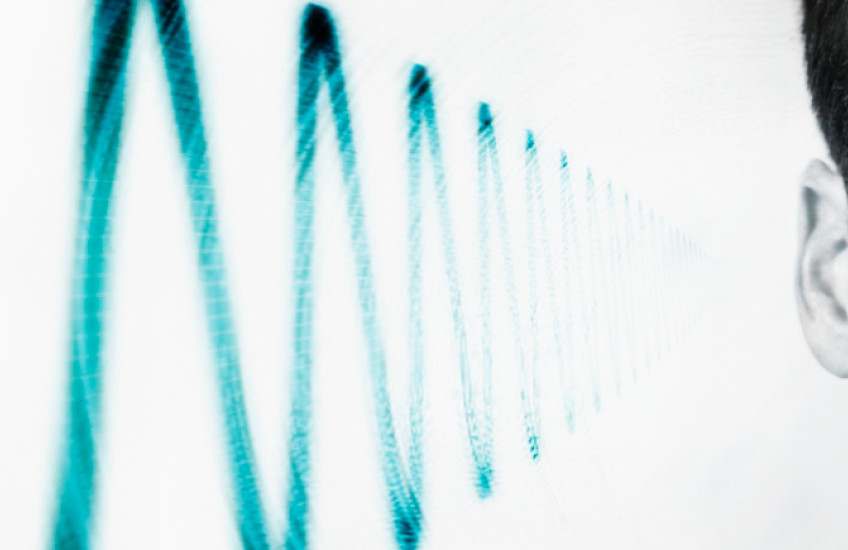 photo of side of man's head showing sound wave near ear