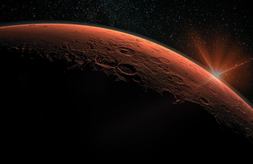 Space photo of Mars with a rising planet behind it