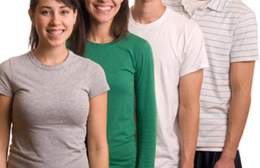 four young people stand close together. their heights rise by a few inches with each person