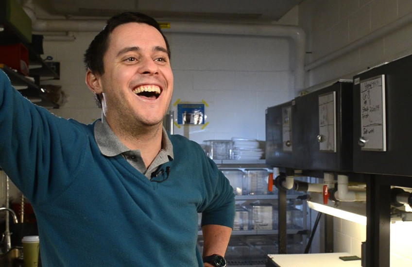 A scientist laughs in a lab