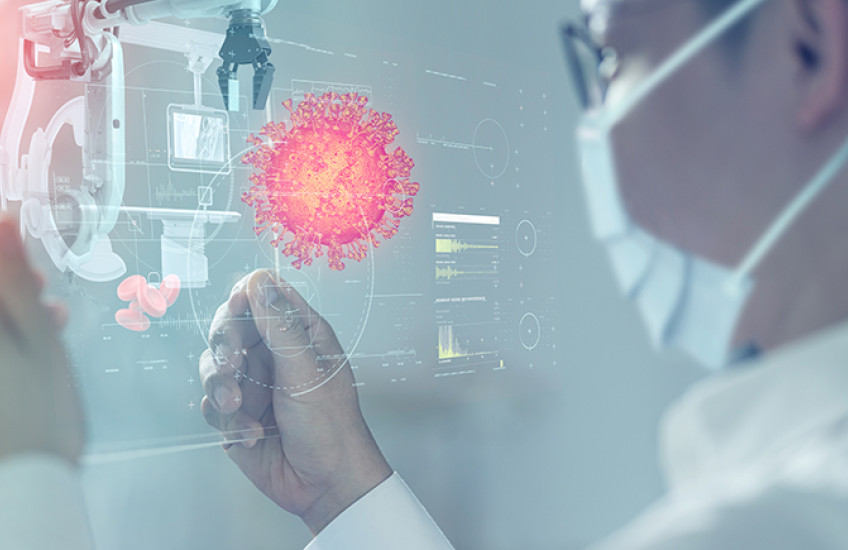 A person wearing a mask examines data on a mobile device.