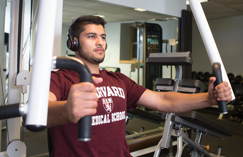 photo of Zaki lifting weights on a chest press machine