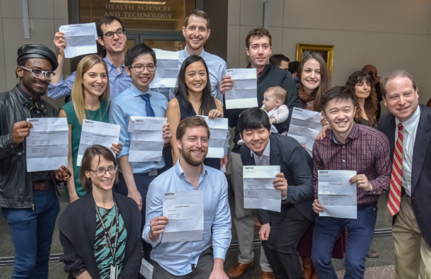 Group of happy HMS Students holding up their Match Day letters.