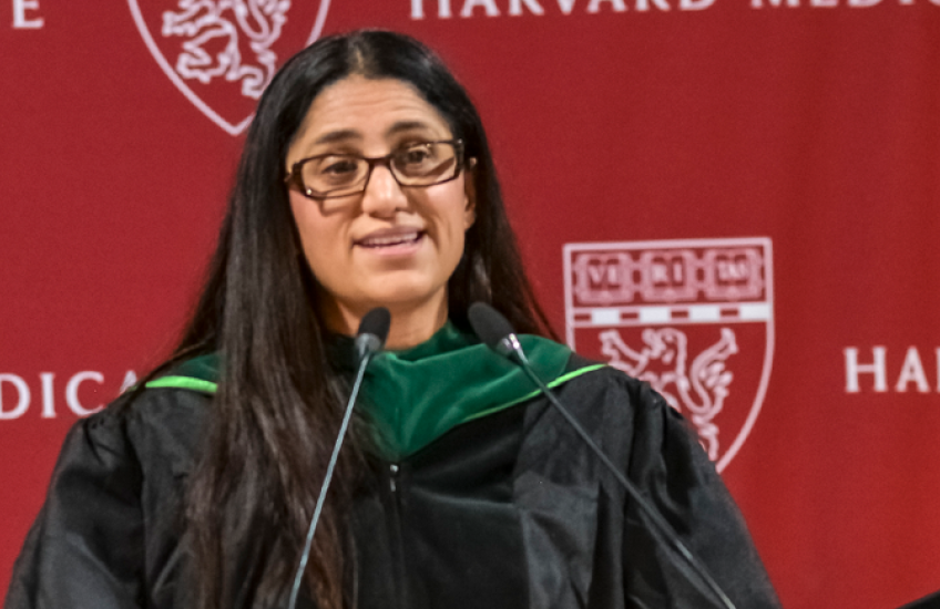 Mona Hanna-Attisha infront of the podium addressing the crowd
