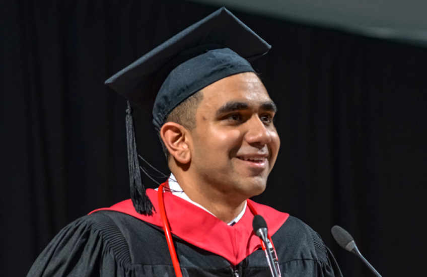 Mubeen Shakir in front of a microphone