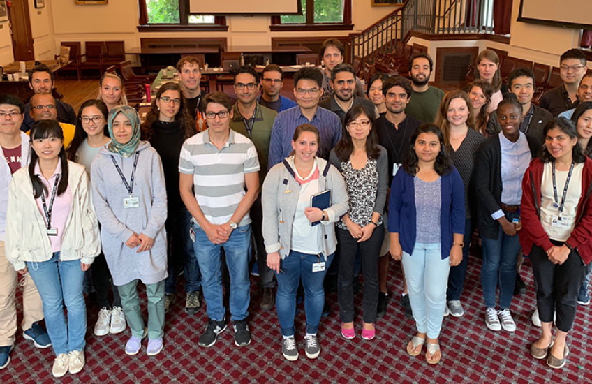 Group of diverse young people posing for photo in a meeting room