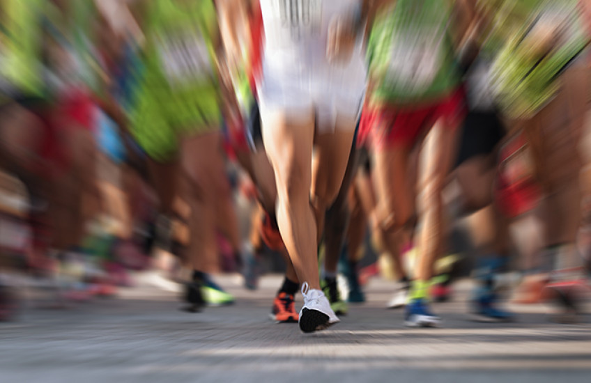 blurred image of runners' legs