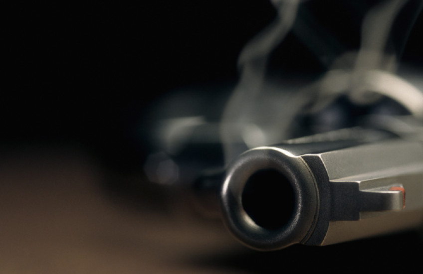 Smoking handgun on a table.