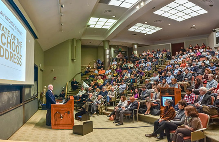 George Q. Daley speaks to an audience. 