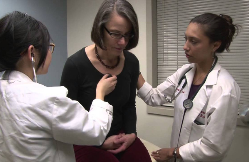 Two doctors check out a patient