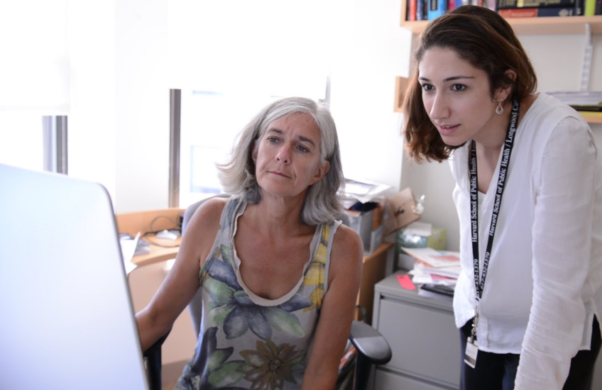 Two scientists look at a computer