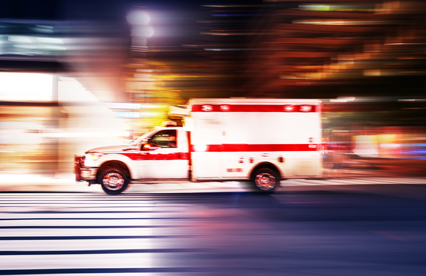 Ambulance speeding at night with motion blur