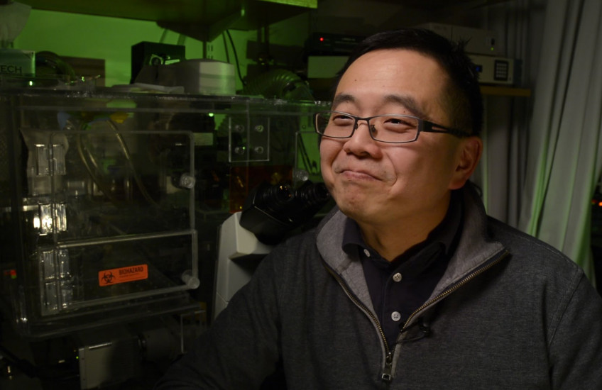 A researcher smiles
