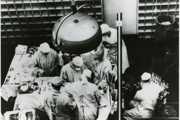 An old photograph of surgeons operating.