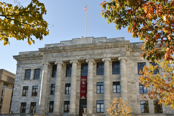 Gordon Hall with a "Welcome Alumni" banner on a fall day