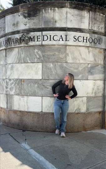 First-year student Tawny Stinson stands in front of the Harvard Medical School entrance.