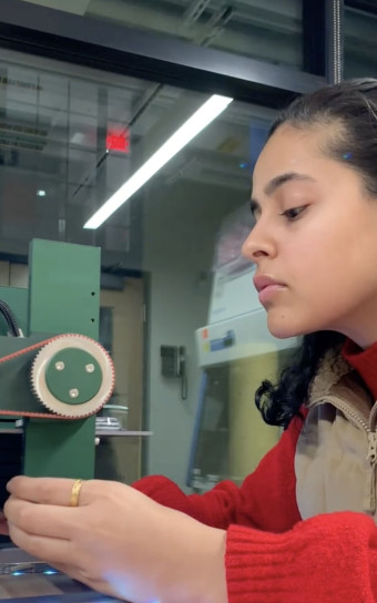 Anna Wadhwa tinkers with equipment in the lab